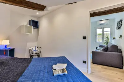 a bedroom with a blue bed and a couch at MY CASA - LA CIVETTE - Place Garibaldi in Nice