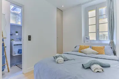 a bedroom with a bed with two pillows on it at MY CASA - LA CIVETTE - Place Garibaldi in Nice