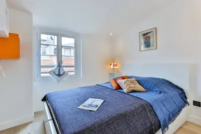 a bedroom with a bed with a book on it at MY CASA - LA CIVETTE - Place Garibaldi in Nice