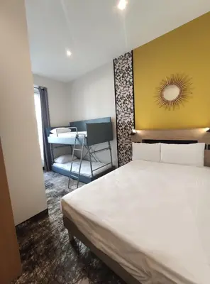 a hotel room with a bed and a desk at Hotel d'Ostende in Nice