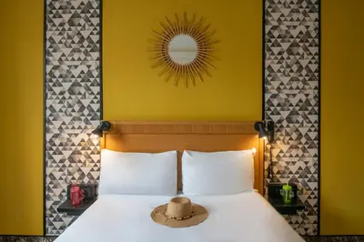 a hat sitting on a bed in a hotel room at Hotel d'Ostende in Nice