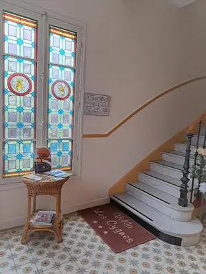 a room with a staircase and a stained glass window at Hotel Villa Les Cygnes in Nice