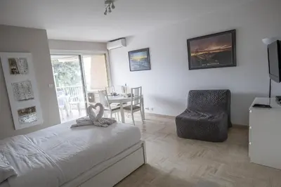 a bedroom with a bed and a chair and a table at Maresol in Cagnes-sur-Mer