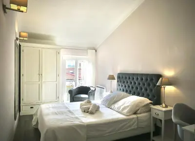 a bedroom with a bed with a teddy bear on it at Promenade sur les toits in Nice