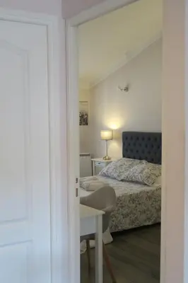 a bedroom with a bed and a table and a desk at Promenade sur les toits in Nice
