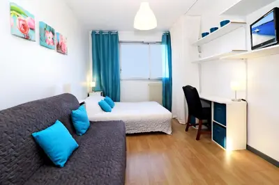 a bedroom with a bed and a desk with a bed and a desk at SOPHIES HOMES APARTEMENT BEACH and PROMENADE DES ANGLAIS in Nice