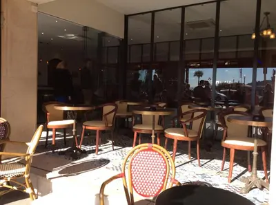 a group of tables and chairs in a restaurant at Hotel La Regence in Villefranche-sur-Mer