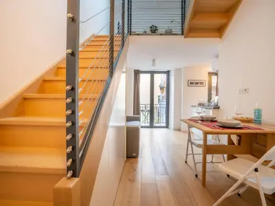 a kitchen and dining room with a staircase and a table at Apartment Wilson by Interhome in Nice