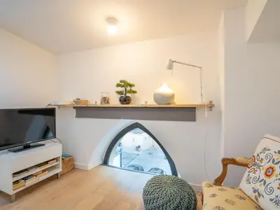 a living room with a fireplace with a window at Apartment Wilson by Interhome in Nice