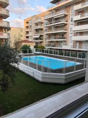an external view of a building with a swimming pool at Palais des domes in Nice
