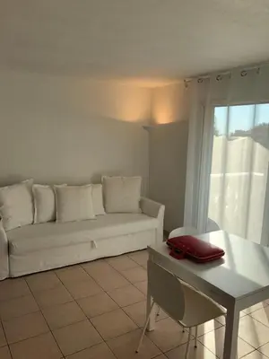 a living room with a white couch and a table at Palais des domes in Nice