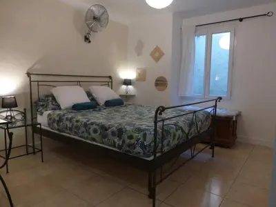 a bedroom with a bed and a window and a fan at 6 bedrooms seaview house, Old Town in Nice