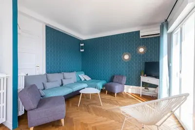 a living room with a blue couch and chairs at 6 bedrooms seaview house, Old Town in Nice