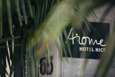 a sign that says home holley nike next to a plant at Arome Hôtel in Nice
