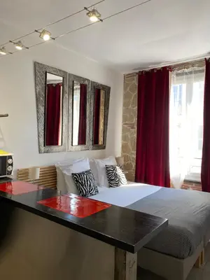 a bedroom with a large bed and a table at Intérieurs-Cour in Nice
