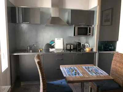 a small kitchen with a table and a sink at Intérieurs-Cour in Nice