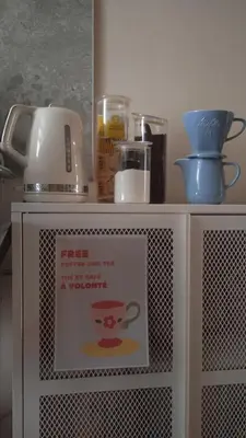 a shelf with a sign on top of a microwave at Open House #hostel in Nice