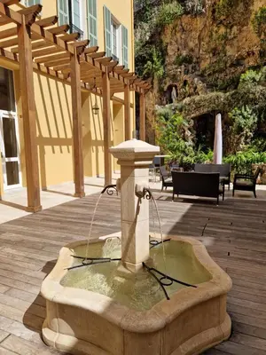 a person eating a plate of food on a table at Hotel Le Saint Paul in Nice
