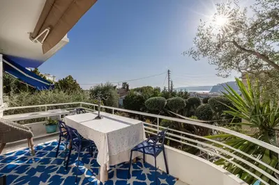 a patio with a table and chairs on a balcony at Villa Iris in Nice