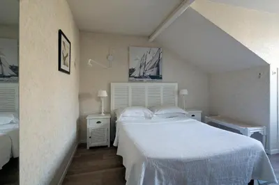 a bedroom with two beds and two night stands at Villa Saint Hubert in Nice