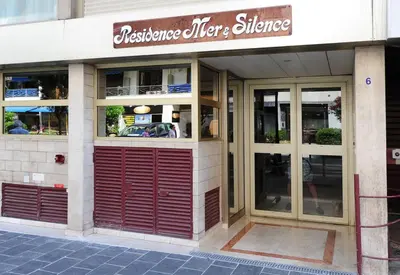 a restaurant with a red door and a sign on it at Studio Massenet Five stars holiday house in Nice