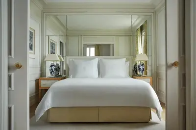 a bedroom with a large white bed and a balcony at Grand-Hôtel du Cap-Ferrat, A Four Seasons Hotel in Saint-Jean-Cap-Ferrat