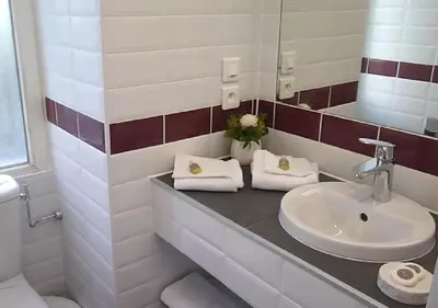 a bathroom with a sink and a mirror at Nice Appart in Nice