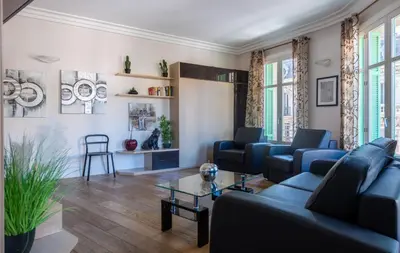 a living room with blue couches and a table at VICTOR HUGO - Modern and sunny, terrace, 2 baths in Nice