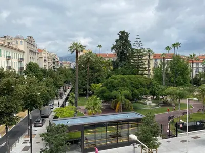 a building in a city with trees and a street at VICTOR HUGO - Modern and sunny, terrace, 2 baths in Nice