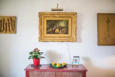 a painting on a wall above a table with a bowl of fruit at La Providence Nice in Nice