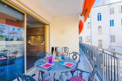 a patio with a table and chairs on a balcony at Le Joffre Grimaldi Nice AP2089 in Nice