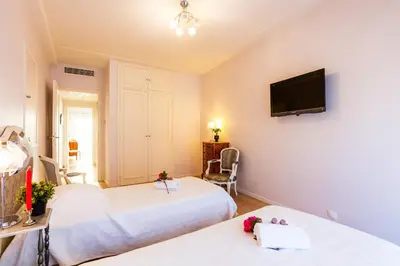 a room with two beds and a flat screen tv at Le Joffre Grimaldi Nice AP2089 in Nice