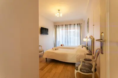 a hotel room with two beds and a window at Le Joffre Grimaldi Nice AP2089 in Nice