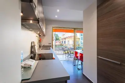 a kitchen with a counter and a dining room at Le Joffre Grimaldi Nice AP2089 in Nice