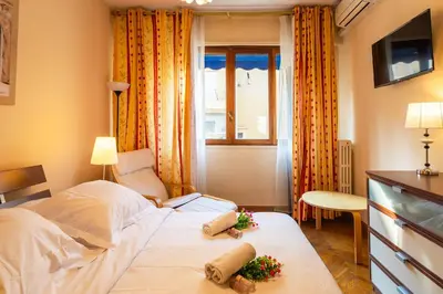 a bedroom with a large bed with flowers on it at LE FRANCE-MASSENET AP3015 by Riviera Holiday Homes in Nice