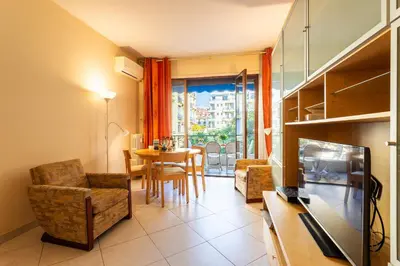 a living room with a table and a dining room at LE FRANCE-MASSENET AP3015 by Riviera Holiday Homes in Nice