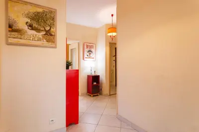 a hallway with a red refrigerator in a room at LE FRANCE-MASSENET AP3015 by Riviera Holiday Homes in Nice