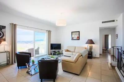 a living room with a couch and a table at Vinaigrier Hills VI3086 by Riviera Holiday Homes in Nice