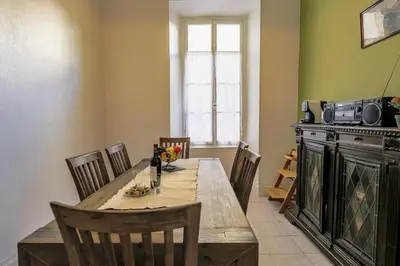 a dining room with a wooden table and chairs at VIA ITALIA AP1054 - By Riviera Holiday Homes in Nice