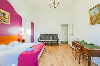 a bedroom with a bed and a desk and a chair at VIA ITALIA AP1054 - By Riviera Holiday Homes in Nice