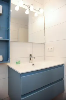 a shower with a shower head and a glass door at Suite ST Geneviève Five stars holiday house in Nice