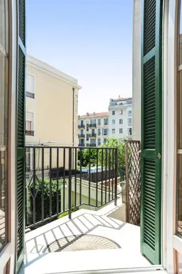 a table with a plate of food and flowers on it at Suite ST Geneviève Five stars holiday house in Nice