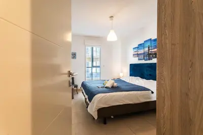 a bedroom with a dog laying on a bed at JARDINS MASSENA AP4088 Nice, by Riviera Holiday Homes in Nice