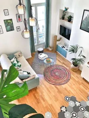 a living room with a couch and a table at Homelivia, Appart FRIDA, mezzanine, déco raffinée et balcon in Nice