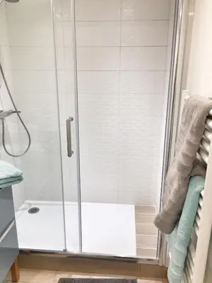 a shower with a glass door in a bathroom at Homelivia, Appart FRIDA, mezzanine, déco raffinée et balcon in Nice