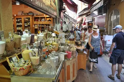 a group of people walking around a market in a store at Charmant studio tout proche du port in Nice