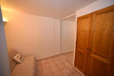 a room with a couch and a wooden door at La Plenitude in Cagnes-sur-Mer