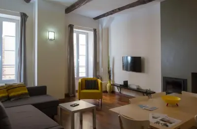 a living room with a couch and a table at Magnifiques Appartements au coeur du Vieux Nice in Nice