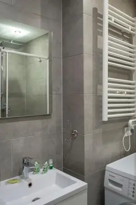 a bathroom with a sink and a mirror at Magnifiques Appartements au coeur du Vieux Nice in Nice
