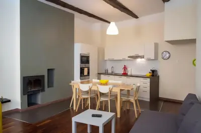 a kitchen and dining room with a table and chairs at Magnifiques Appartements au coeur du Vieux Nice in Nice